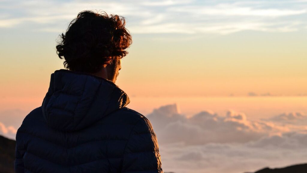 Pessoa olhando para o céu refletindo sobre os sinais da volta de Jesus em Mateus 24